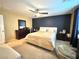 Relaxing main bedroom with ceiling fan and dark-accent wall at 10636 Tulip Valley Rd, Las Vegas, NV 89179