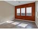 Bright living room with three windows and red accent wall at 11287 Idyllic Dr # 102, Las Vegas, NV 89135