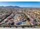 Wide aerial shot captures a residential neighborhood with houses, streets, and distant mountain views at 1138 Gainesborough Ct, Henderson, NV 89015