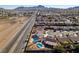 Aerial perspective capturing neighborhood homes with backyard pools, roads, and desert scenery at 1138 Gainesborough Ct, Henderson, NV 89015