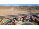 Desert backdrop frames an aerial view showcasing neighborhood homes, paved roads, and arid landscape at 1138 Gainesborough Ct, Henderson, NV 89015