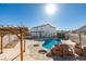 A backyard pool featuring mature landscaping, a pergola, and desert views at 1138 Gainesborough Ct, Henderson, NV 89015