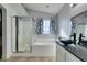 Bathroom featuring a glass-enclosed shower and a bathtub with a glass sink at 1138 Gainesborough Ct, Henderson, NV 89015