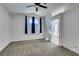 Bedroom with carpeted floor, a ceiling fan, and a view of the attached bathroom at 1138 Gainesborough Ct, Henderson, NV 89015