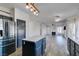 Modern kitchen featuring stainless steel appliances and a central island with a view into the spacious living room at 1138 Gainesborough Ct, Henderson, NV 89015