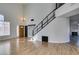 Open-concept living room featuring wood floors, staircase with metal railing, and high ceilings at 1138 Gainesborough Ct, Henderson, NV 89015