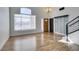 Bright living room with wood floors, high ceilings, large windows and modern chandelier at 1138 Gainesborough Ct, Henderson, NV 89015