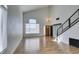 Open living area features wood flooring, a modern light fixture and natural light from a window at 1138 Gainesborough Ct, Henderson, NV 89015