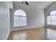 A bright living room showcasing wood floors and large windows that let in natural light at 1138 Gainesborough Ct, Henderson, NV 89015