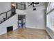 Bright living room showcasing wood floors, staircase, and large window letting in natural light at 1138 Gainesborough Ct, Henderson, NV 89015