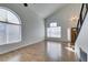 Bright living room featuring vaulted ceilings, wood floors, and an arched window offering ample light at 1138 Gainesborough Ct, Henderson, NV 89015