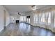 Large, open living room featuring wood-look floors, a fireplace, and natural light from numerous windows at 1138 Gainesborough Ct, Henderson, NV 89015