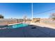 A backyard pool with a rock waterfall feature, concrete decking, and pergola seating area at 1138 Gainesborough Ct, Henderson, NV 89015