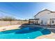 Backyard view of the house from the pool with a partially covered patio at 1138 Gainesborough Ct, Henderson, NV 89015