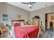 Bedroom with red bedding, ceiling fan and wood-look floors at 114 Harbor View Dr # 0, Boulder City, NV 89005