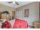 Bedroom with red bedding, ceiling fan, and wood-look floors at 114 Harbor View Dr # 1025, Boulder City, NV 89005