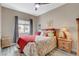 Cozy bedroom with red bedding, wood-look floors, and a ceiling fan at 114 Harbor View Dr # 1025, Boulder City, NV 89005