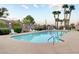 Inviting community pool with lounge chairs and palm trees at 114 Harbor View Dr # 0, Boulder City, NV 89005