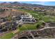 Aerial shot of a large clubhouse overlooking a well-manicured golf course and surrounding upscale residences at 12 Bloomfield Hills Dr, Henderson, NV 89052