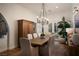 Elegant dining room with large wood table and chandelier at 12 Bloomfield Hills Dr, Henderson, NV 89052