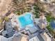 Aerial view of a community pool and lounge area, surrounded by palm trees and cabanas at 12 Bloomfield Hills Dr, Henderson, NV 89052