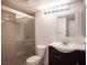 This renovated bathroom offers a tile surround, walk-in shower, and dark vanity at 1701 E Katie Ave # 65, Las Vegas, NV 89119