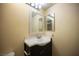 Bathroom features a dark vanity with a white sink and a large decorative mirror at 1701 E Katie Ave # 65, Las Vegas, NV 89119