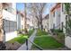 Building exteriors with grass, trees, and a walkway between the apartments at 1701 E Katie Ave # 65, Las Vegas, NV 89119