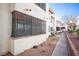 Apartment building exterior with sidewalk, desert landscaping, and security bars on the windows at 1701 E Katie Ave # 65, Las Vegas, NV 89119