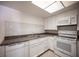 Well-lit kitchen with white cabinets, modern appliances, and stylish backsplash tiles at 1701 E Katie Ave # 65, Las Vegas, NV 89119