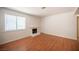 Living room featuring hardwood floors, fireplace and natural light from window at 1701 E Katie Ave # 65, Las Vegas, NV 89119