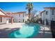 Community pool surrounded by landscaping and nearby buildings at 1701 E Katie Ave # 65, Las Vegas, NV 89119