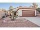 Single-story home with a two-car garage and landscaped front yard at 1859 Cypress Greens Ave, Henderson, NV 89012