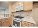 White appliances and light wood cabinets in this kitchen at 1859 Cypress Greens Ave, Henderson, NV 89012