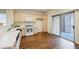 Kitchen with light wood cabinets, white appliances, and wood-look floors at 1859 Cypress Greens Ave, Henderson, NV 89012