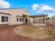 A spacious backyard featuring a covered patio and desert landscaping at 2026 Dakota Lodge Ave, Las Vegas, NV 89123