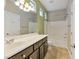 This bathroom includes a spacious countertop with vanity and a shower-tub combo with bright lighting at 2026 Dakota Lodge Ave, Las Vegas, NV 89123