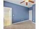 Spacious bedroom offering neutral carpeting, blue accent wall, and an adjacent bathroom at 2026 Dakota Lodge Ave, Las Vegas, NV 89123