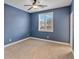 Bedroom boasts blue walls, natural light from the window and plush carpeting throughout at 2026 Dakota Lodge Ave, Las Vegas, NV 89123