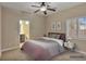 Comfortable bedroom featuring neutral tones, plush carpeting, and a ceiling fan for added comfort at 2026 Dakota Lodge Ave, Las Vegas, NV 89123