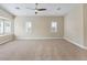 Bright, carpeted room with neutral walls, ceiling fan and large windows with window shutters at 2026 Dakota Lodge Ave, Las Vegas, NV 89123