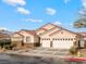 Charming single-story home with a tile roof, three-car garage, and well-maintained landscaping at 2026 Dakota Lodge Ave, Las Vegas, NV 89123