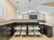 Open kitchen with dark wood cabinets, granite countertops, and pull-out shelving at 2026 Dakota Lodge Ave, Las Vegas, NV 89123