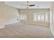 Bright and airy main bedroom with neutral carpet, ceiling fan, and large windows with plantation shutters at 2026 Dakota Lodge Ave, Las Vegas, NV 89123