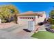 Single-story house with a two-car garage and American flag at 2084 Tiger Links Dr, Henderson, NV 89012