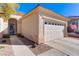 Single-story house with a two-car garage and walkway at 2084 Tiger Links Dr, Henderson, NV 89012