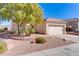 Single-story house with a two-car garage and desert landscaping at 2084 Tiger Links Dr, Henderson, NV 89012