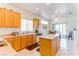 Kitchen with light wood cabinets, an island, and tiled floor at 2084 Tiger Links Dr, Henderson, NV 89012