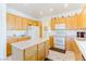 Eat-in kitchen with island and wood cabinets at 2084 Tiger Links Dr, Henderson, NV 89012