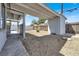 Gravel backyard with covered patio, storage shed, and fence at 209 N 21St St, Las Vegas, NV 89101